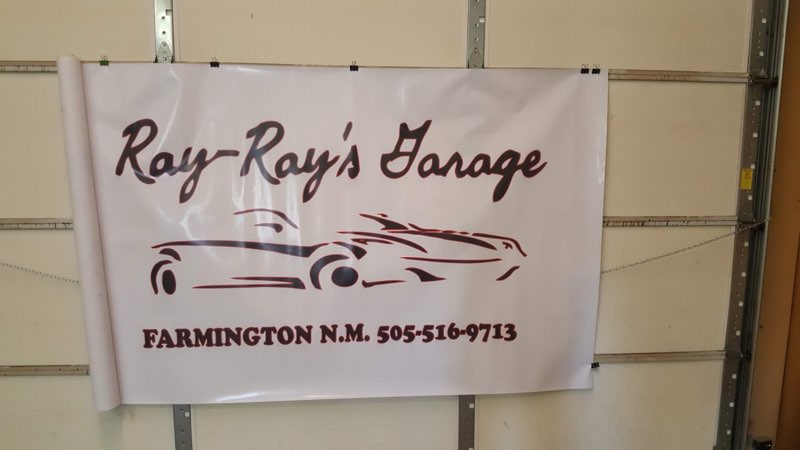 Ray-Ray's Garage banner with its car-silhouette logo and Farmington, N.M. phone number